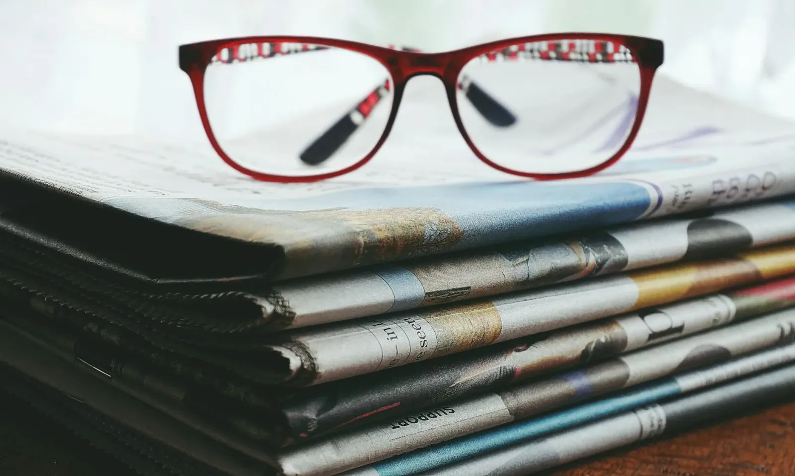 Imajen ida ne'ebé hatudu ema lee notisia iha jornal ida ho lian rua, hanesan sinal ba komprensaun krítiku iha mundu media.