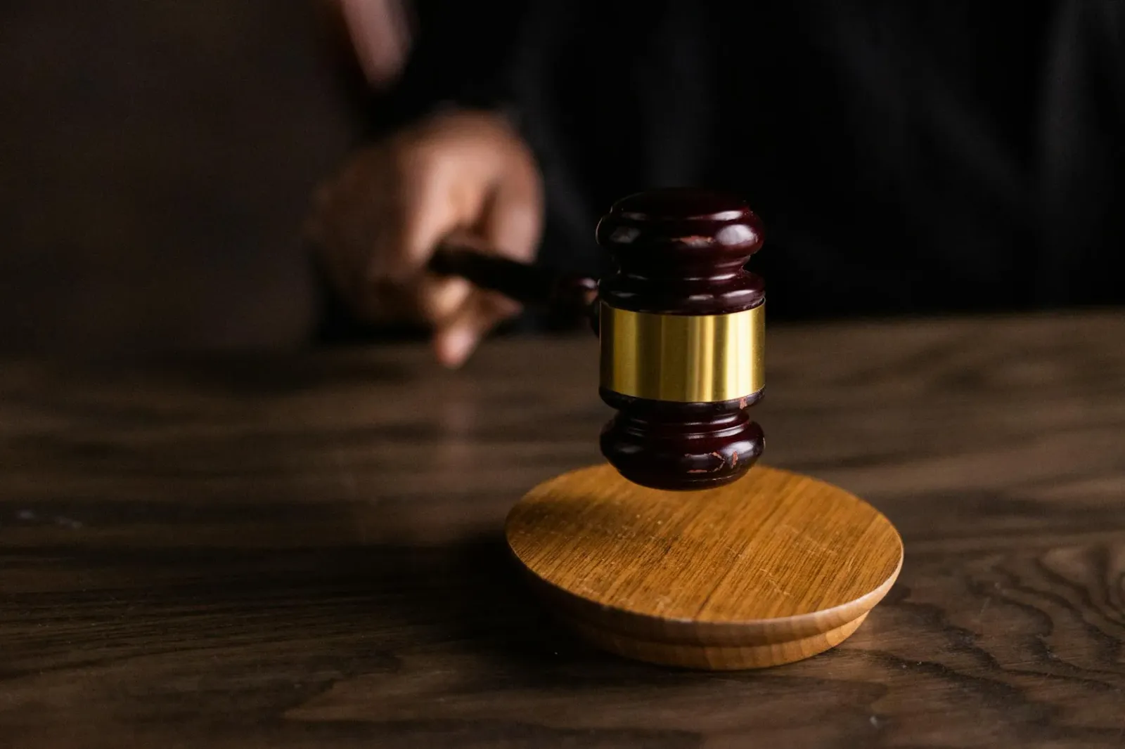 Imajen ne'ebé hatudu martelu tribunal, símbolu astrolojia Libra, no nadaór Olimpiku sira hodi reprezenta ligasaun entre justi
