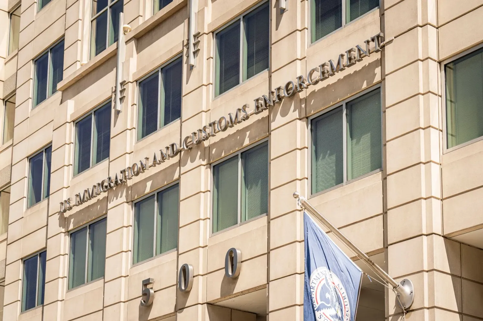 Imajen kona-ba enforcamentu imigrasaun iha fábrika metál, ho símbolu negósiu no dokumentu, hatudu ligasaun entre lei no produ