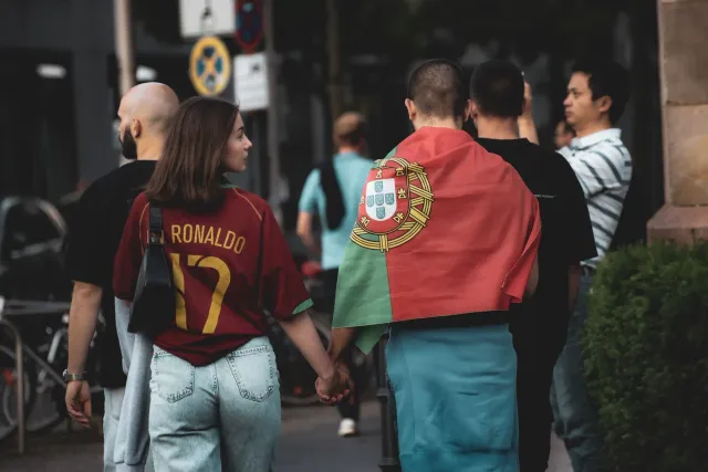 Cristiano Ronaldo sai kapitaun ba Portugal iha FIFA World Cup, ho nia uniforme vermelhu no bandeira Portugal iha kotuk