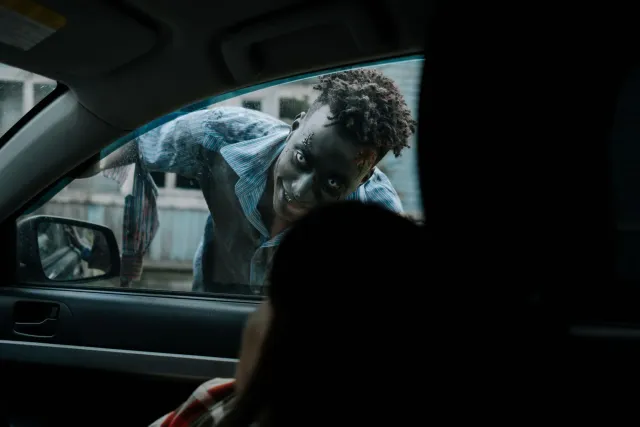 Imajen ida hatudu diretor Yeon Sang-ho iha entrevista, ho nia filme zombie foun nia poster iha kotuk, ne'ebé simboliza avisu 