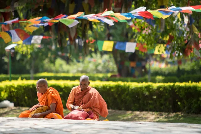Ema sira iha sesaun yoga iha Lumbini, Nepal, ho Eternal Peace Flame iha kotuk, hanesan simbolu saúde no paz