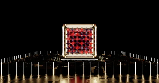 Imajen ida hatudu komputador kuántika IBM ho luz azul no estrutura metáliku, iha fundo sala laboratóriu modernu, ne'ebé repre