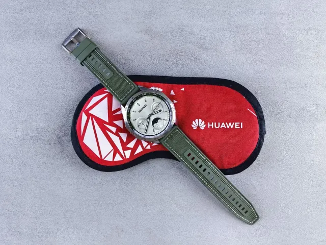 Fotografia smartwatch Huawei Qingyun H3550 iha meja, hatudu monitorizasaun saúde ba empregadu, iha kotuk iha ilustrasaun mikr