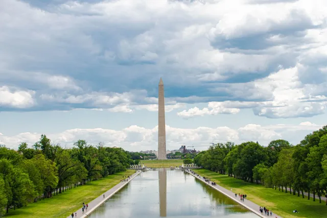 Imajen ida hatudu National Mall reflecting pool iha Washington DC ho ekipamentu reparasaun no bandeira Amerika iha kotuk, sim