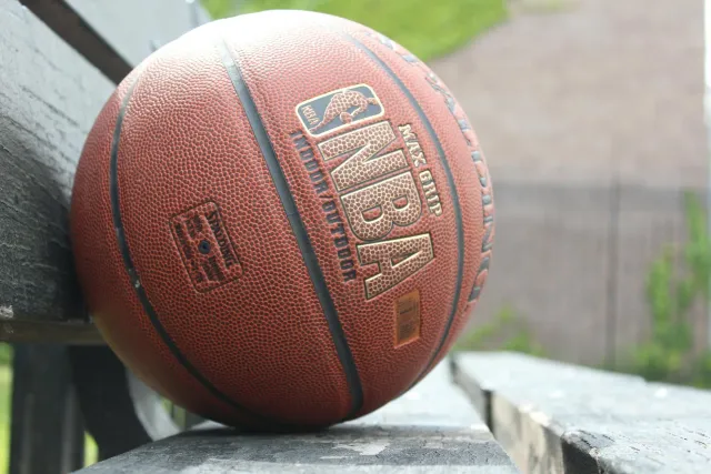 Imajen kanja basket NBA Finals ho logu New York Knicks no San Antonio Spurs iha fundu, hatudu estadiu torcedor sira no luz br