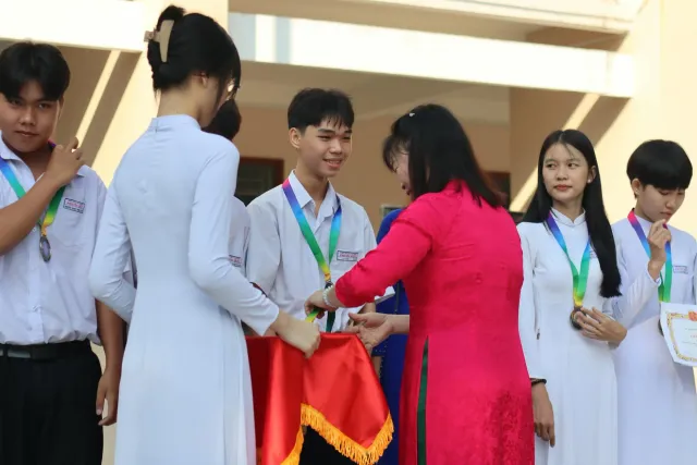 Estudante ida iha serimonia Emmy simu bolsa estudu ho sorriso, iha kotuk ema barak haree ho orgullu