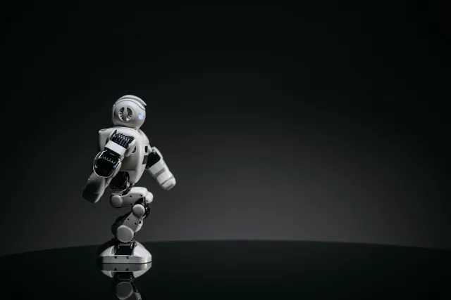 Ilustrasaun kona-ba AI hanesan addiksaun iha empresa, ho ema uza komputador no AI chatbot, maibe sente la balansu no perde ka
